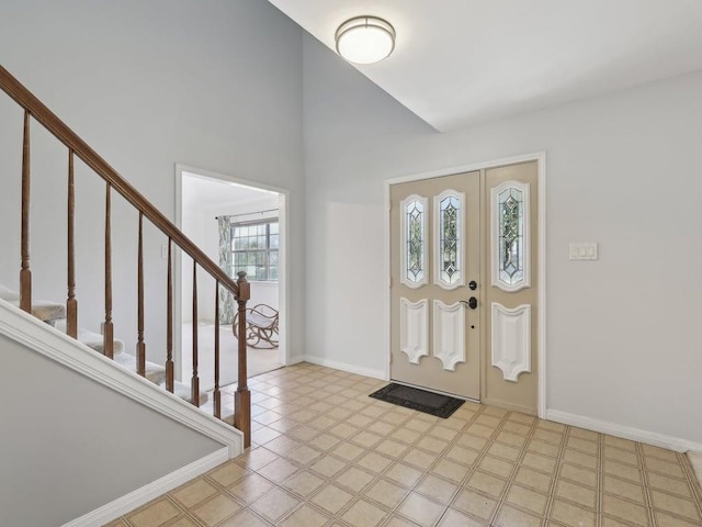 entrance foyer with baseboards and stairway
