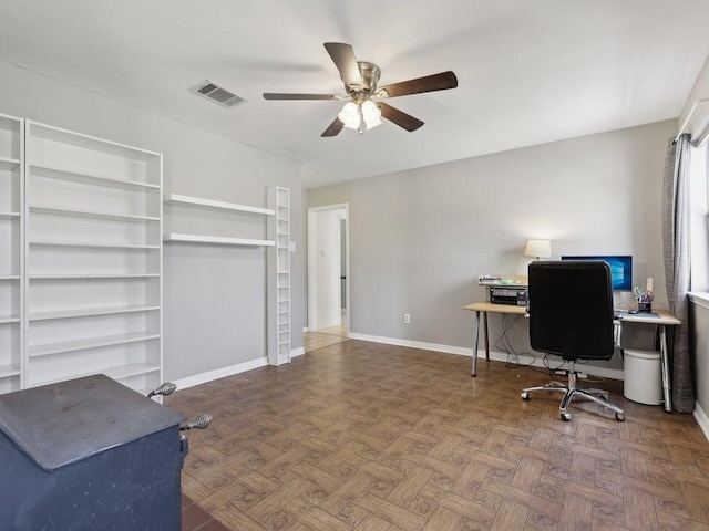 office area featuring visible vents, a ceiling fan, and baseboards