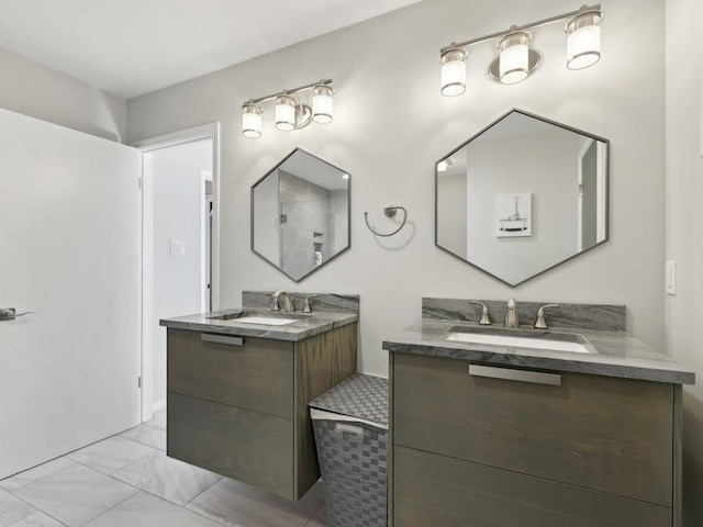 full bathroom featuring two vanities, marble finish floor, and a sink