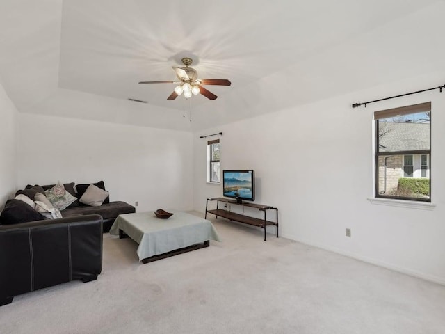 living room featuring carpet, visible vents, ceiling fan, and baseboards