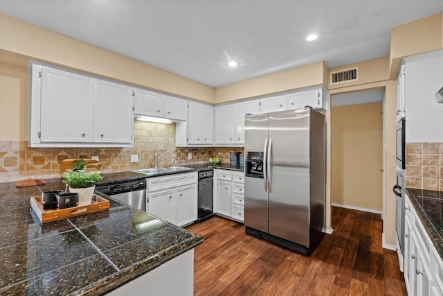 8112 W Ct, Austin, TX 78759 - kitchen with appliances with stainless steel finishes, tile countertops, a sink, dark wood-style floors, and decorative backsplash