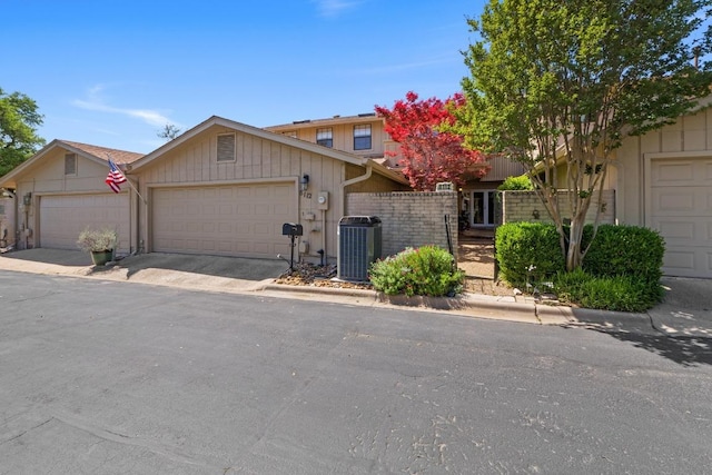 8112 W Ct, Austin, TX 78759 - view of front of property featuring cooling unit, a garage, fence, and driveway
