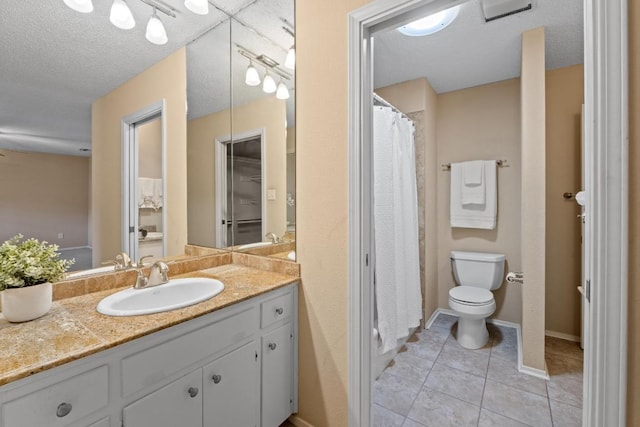 8112 W Ct, Austin, TX 78759 - bathroom with toilet, tile patterned floors, vanity, a textured ceiling, and baseboards