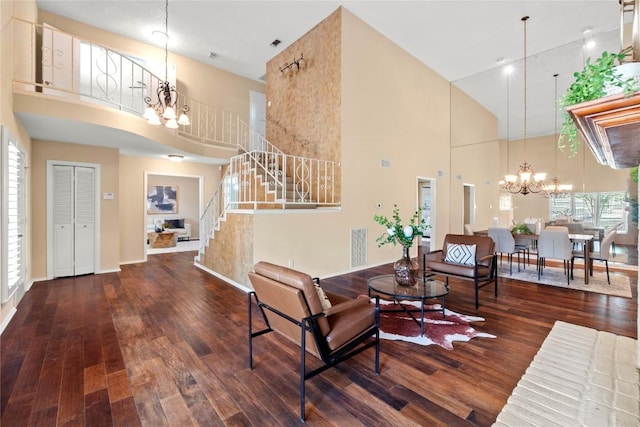 8112 W Ct, Austin, TX 78759 - living room with a chandelier, a towering ceiling, stairs, hardwood / wood-style floors, and baseboards