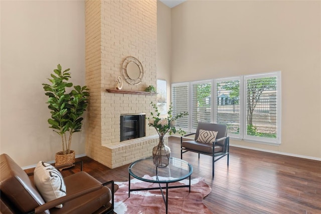 8112 W Ct, Austin, TX 78759 - living room with wood finished floors, baseboards, a fireplace, and a towering ceiling
