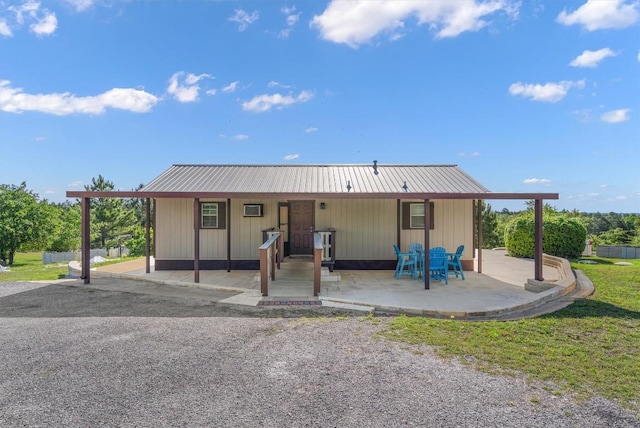 459 Mcallister Rd, Bastrop, TX 78602 - back of house with a metal roof and a lawn