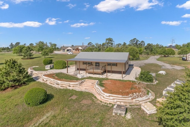 459 Mcallister Rd, Bastrop, TX 78602 - rear view of house with metal roof, a lawn, and a porch