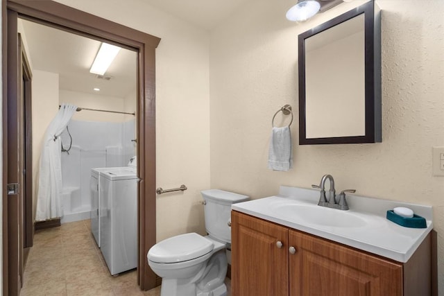 459 Mcallister Rd, Bastrop, TX 78602 - bathroom with separate washer and dryer, vanity, toilet, a shower, and tile patterned floors