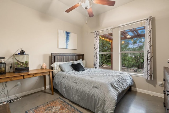 bedroom with finished concrete flooring, baseboards, and a ceiling fan