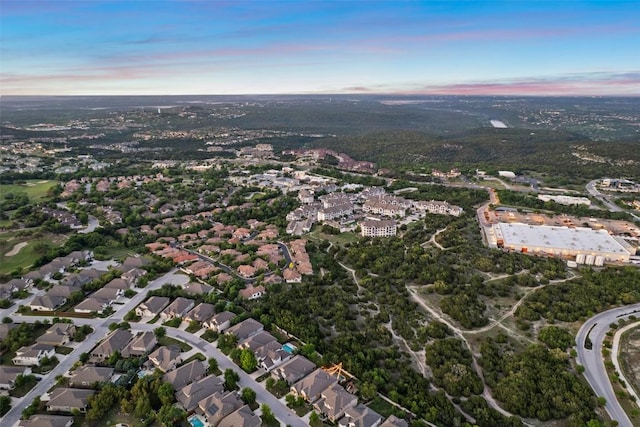 aerial view at dusk featuring a residential view