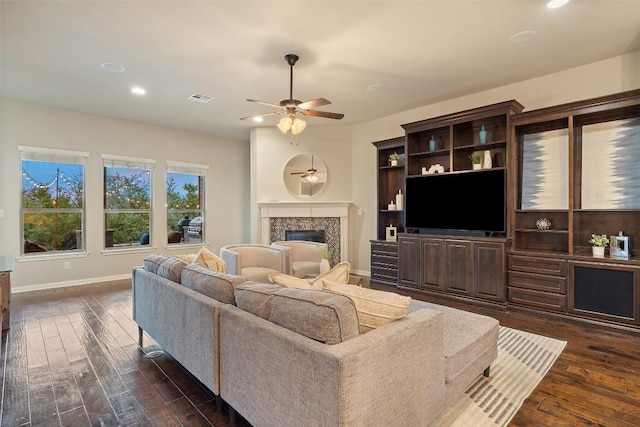 living area with visible vents, dark wood-style flooring, ceiling fan, recessed lighting, and a premium fireplace