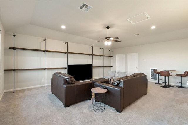 living area featuring visible vents, baseboards, and light carpet