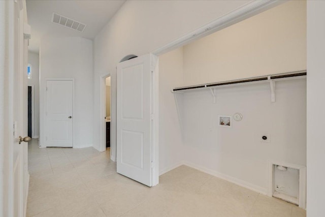 136 Gamble St, Buda, TX 78610 - laundry room featuring electric dryer hookup, washer hookup, and light tile patterned floors
