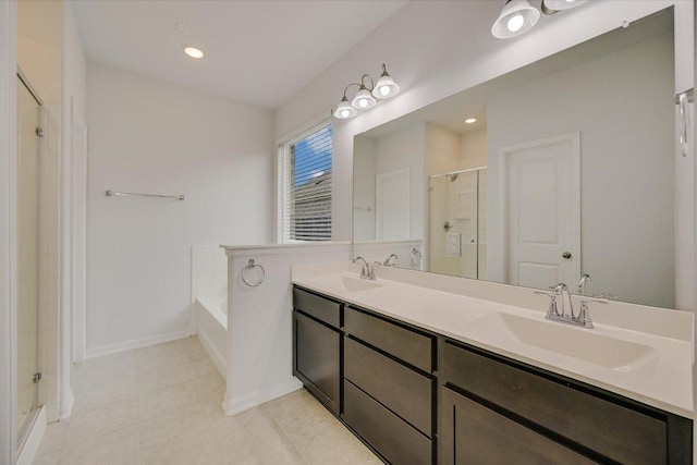 136 Gamble St, Buda, TX 78610 - bathroom with a stall shower, a garden tub, double vanity, and tile patterned flooring