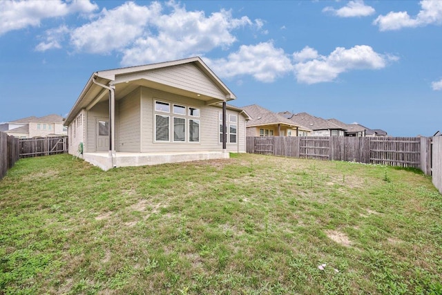 136 Gamble St, Buda, TX 78610 - rear view of house featuring a fenced backyard and a patio area