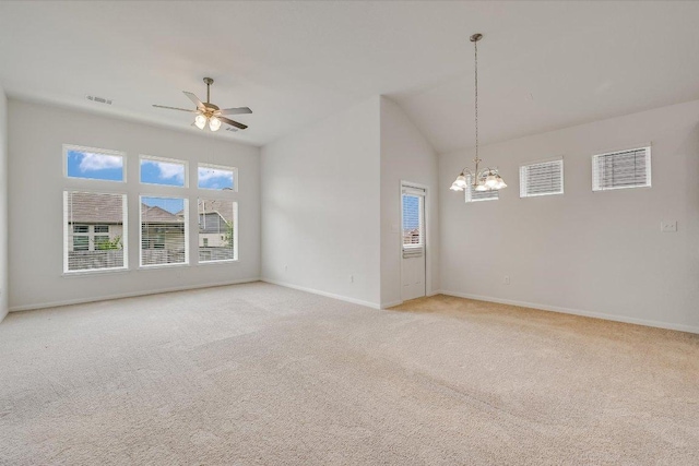 136 Gamble St, Buda, TX 78610 - empty room with a chandelier, healthy amount of natural light, light colored carpet, vaulted ceiling, and ceiling fan