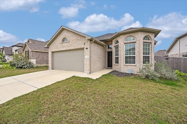 136 Gamble St, Buda, TX 78610 - view of front of house featuring an attached garage, concrete driveway, and brick siding