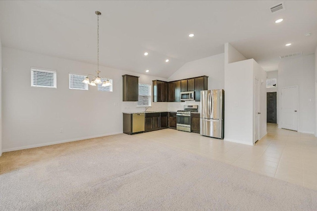 136 Gamble St, Buda, TX 78610 - kitchen with stainless steel appliances, dark brown cabinets, a chandelier, light countertops, and recessed lighting