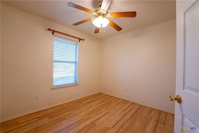 empty room featuring baseboards, light wood finished floors, and a ceiling fan