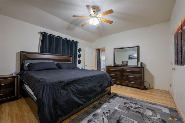 bedroom featuring light wood-style floors, a ceiling fan, and vaulted ceiling