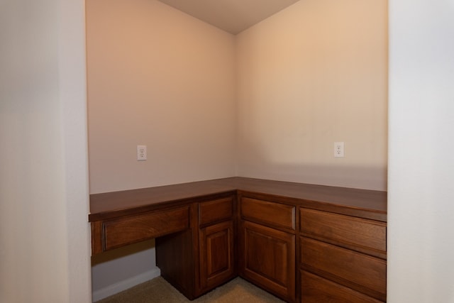 unfurnished office featuring built in desk
