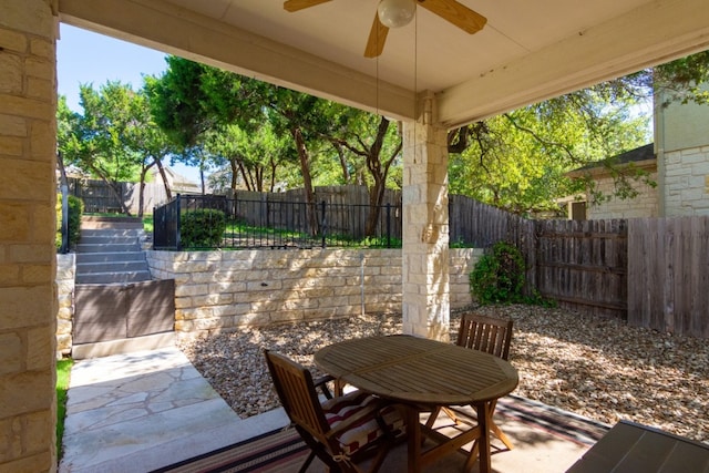 view of patio featuring a fenced backyard, outdoor dining space, and ceiling fan