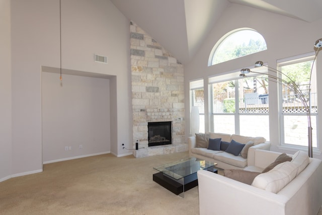 carpeted living room featuring baseboards, a fireplace, visible vents, and high vaulted ceiling