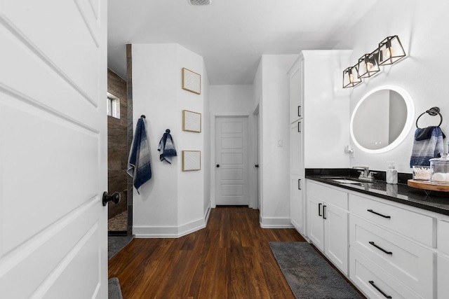213 Pecan Meadow Ln, Harker Heights, TX 76513 - bathroom with wood finished floors, vanity, baseboards, and walk in shower