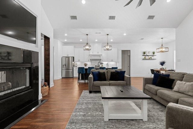 213 Pecan Meadow Ln, Harker Heights, TX 76513 - living area featuring visible vents, recessed lighting, an inviting chandelier, and dark wood-style floors