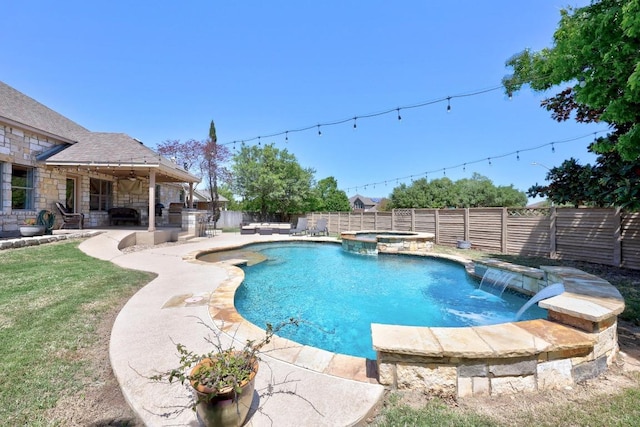 view of pool with a fenced backyard, a pool with connected hot tub, and a patio