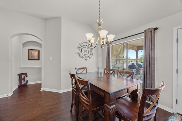 dining room with baseboards, a notable chandelier, and wood finished floors