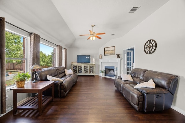 living room featuring ceiling fan, vaulted ceiling, visible vents, and dark wood-style flooring