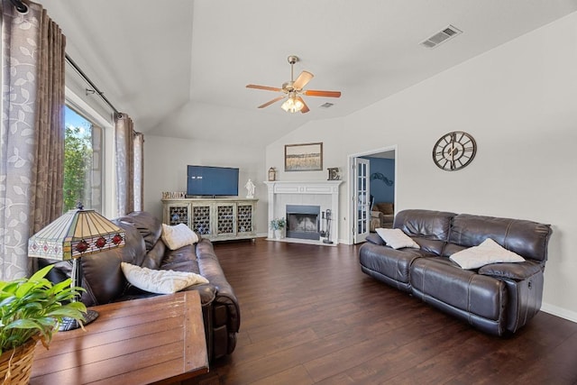 living area with ceiling fan, visible vents, wood finished floors, lofted ceiling, and baseboards