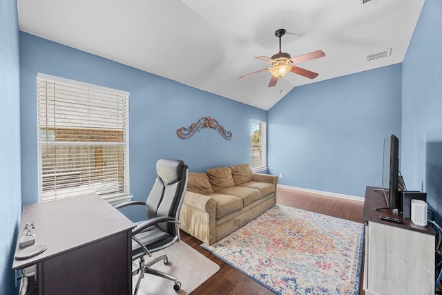 office featuring baseboards, visible vents, ceiling fan, lofted ceiling, and wood finished floors