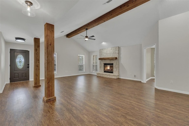 unfurnished living room with dark wood finished floors, a ceiling fan, vaulted ceiling with beams, and plenty of natural light