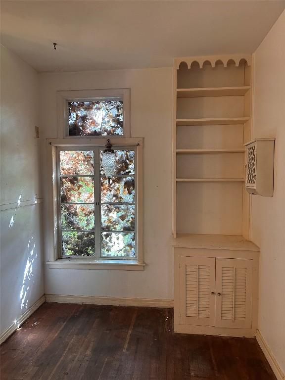 1006 Gilmore St, Taylor, TX 76574 - unfurnished dining area with dark wood finished floors and baseboards