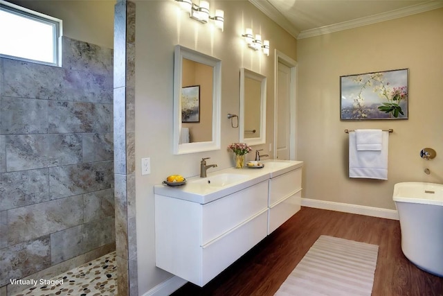 159 Alele Dr, Bastrop, TX 78602 - full bathroom with wood finished floors, double vanity, a walk in shower, crown molding, and a soaking tub