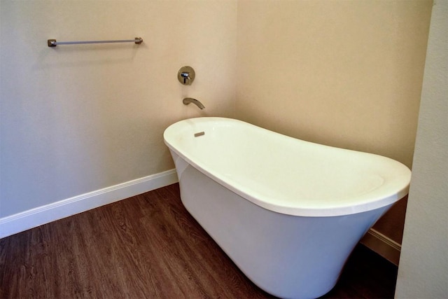 159 Alele Dr, Bastrop, TX 78602 - bathroom featuring a freestanding tub and wood finished floors
