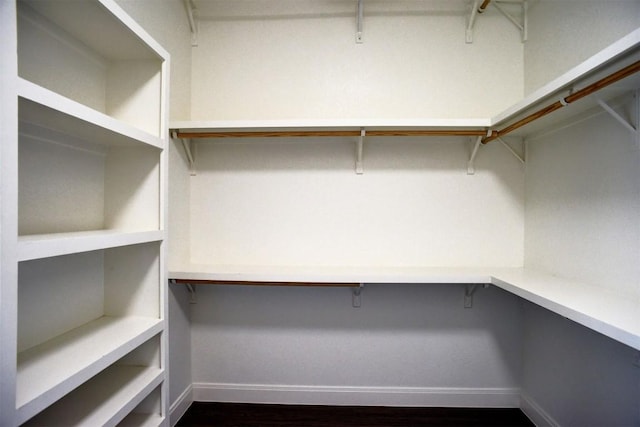 159 Alele Dr, Bastrop, TX 78602 - walk in closet with dark wood-style flooring