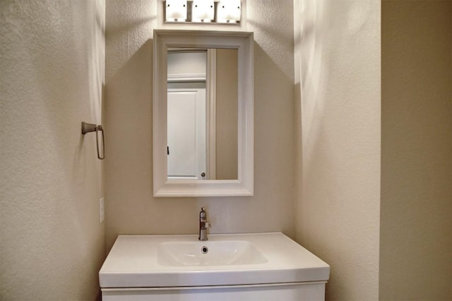 159 Alele Dr, Bastrop, TX 78602 - bathroom featuring a textured wall and vanity