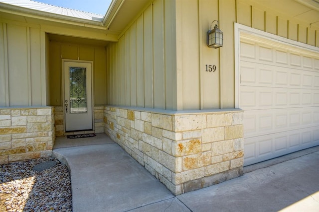 159 Alele Dr, Bastrop, TX 78602 - property entrance with board and batten siding, stone siding, and a metal roof