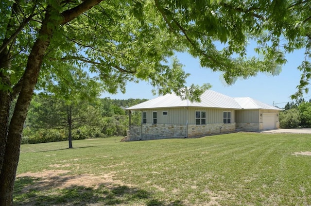 159 Alele Dr, Bastrop, TX 78602 - view of front facade featuring stone siding, an attached garage, a front lawn, and driveway