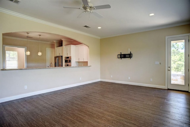 159 Alele Dr, Bastrop, TX 78602 - unfurnished living room with dark wood-style floors, a ceiling fan, ornamental molding, and recessed lighting