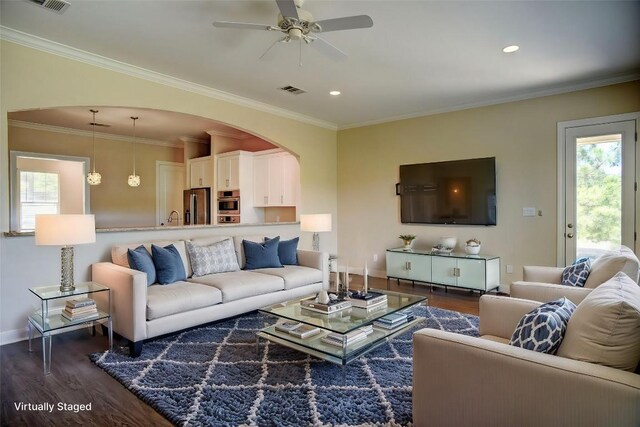 159 Alele Dr, Bastrop, TX 78602 - living room featuring dark wood-style floors, ceiling fan, recessed lighting, ornamental molding, and arched walkways