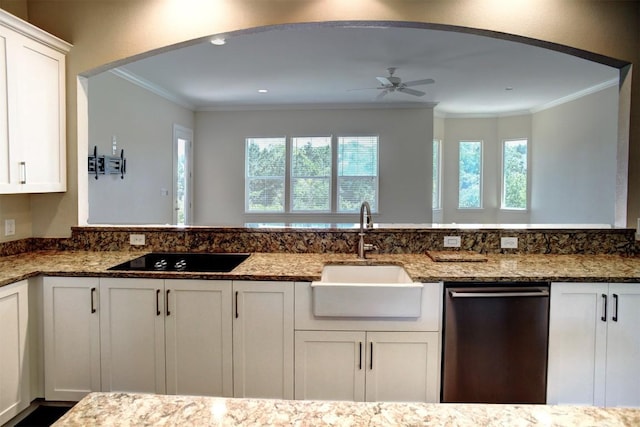 159 Alele Dr, Bastrop, TX 78602 - kitchen with stainless steel dishwasher, black electric cooktop, ceiling fan, crown molding, and white cabinets