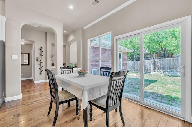dining room with baseboards, recessed lighting, crown molding, light wood-style floors, and visible vents