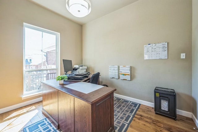 home office featuring light wood finished floors and baseboards