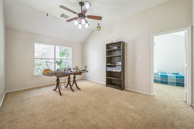carpeted office space with visible vents, ceiling fan, baseboards, and lofted ceiling