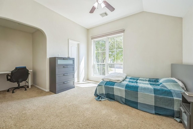 bedroom featuring vaulted ceiling, a ceiling fan, visible vents, arched walkways, and carpet