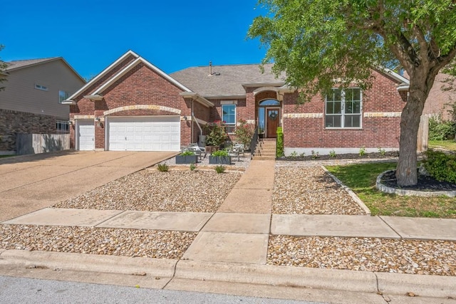 ranch-style home with brick siding, roof with shingles, an attached garage, and concrete driveway
